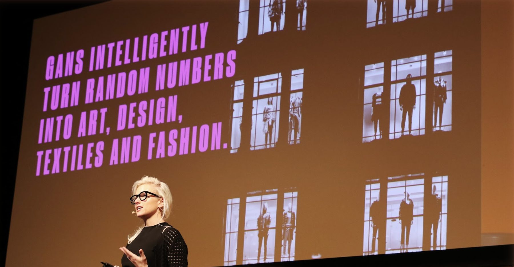 Julia Peter on stage presenting how generative AI turns random numbers into art, design, textiles and fashion